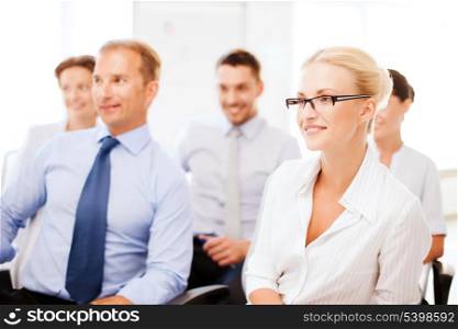 business concept - smiling businessmen and businesswomen on conference