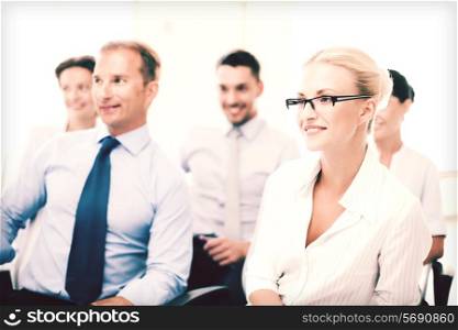 business concept - smiling businessmen and businesswomen on conference