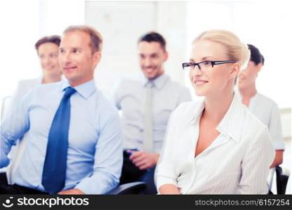 business concept - smiling businessmen and businesswomen on conference. businessmen and businesswomen on conference