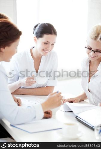 business concept - smiling businesswoman with team on meeting in office