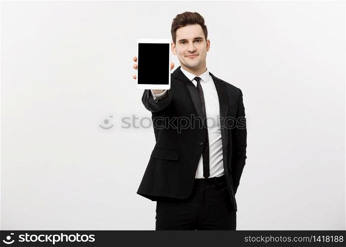 Business Concept: Smiling handsome businessman presenting website or presentation on tablet. Business Concept: Smiling handsome businessman presenting website or presentation on tablet.