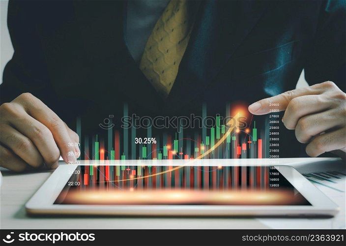 business concept stock market finance Index Fund.businessman holding a graph tablet showing growing virtual hologram stocks. invest in trading
