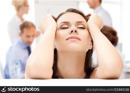 business concept - stressed businesswoman holding her head with hands in office