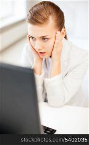 business concept - stressed businesswoman with computer in office