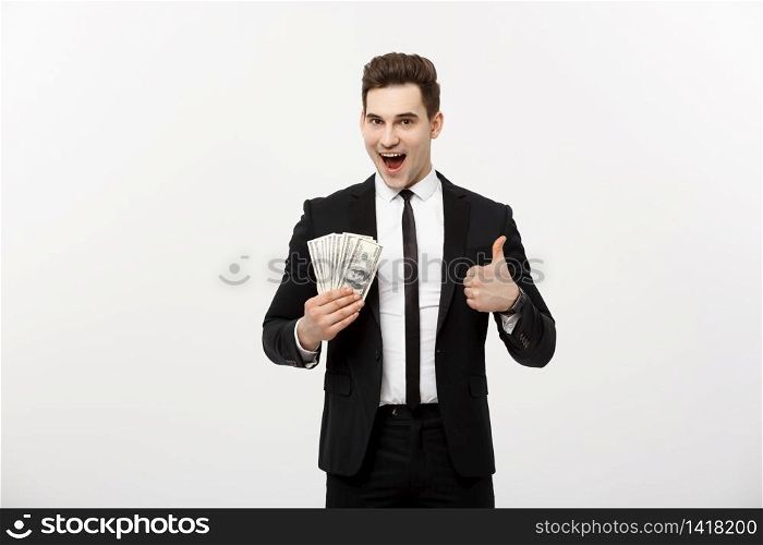 Business Concept - Successful Businessman holding dollar bills and showing thumb up isolated over white background. Business Concept - Successful Businessman holding dollar bills and showing thumb up isolated over white background.