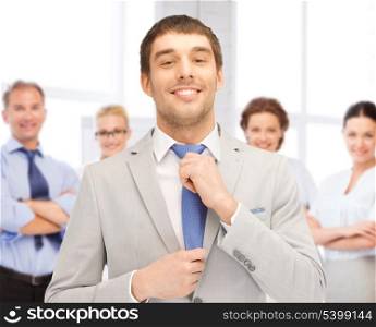 business concept - successful businessman with team in office