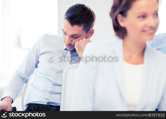 business concept - tired businessmen sleeping on conference or meeting. tired businessmen sleeping on conference