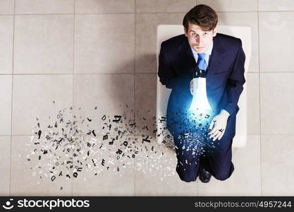 Business concept. Top view of businessman sitting on chair with megaphone