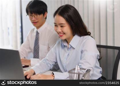 Business concept, Two business colleague checking financial data and typing report on laptop.