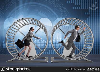 Business concept with pair running on hamster wheel