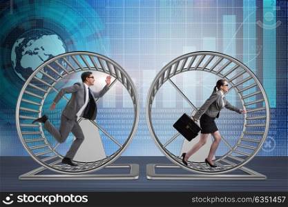 Business concept with pair running on hamster wheel