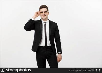 Business Concept: Young handsome businessman wearing glasses holding hand in pocket isolated on white background. Business Concept: Young handsome businessman wearing glasses holding hand in pocket isolated on white background.