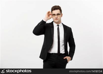 Business Concept: Young handsome businessman wearing glasses holding hand in pocket isolated on white background. Business Concept: Young handsome businessman wearing glasses holding hand in pocket isolated on white background.