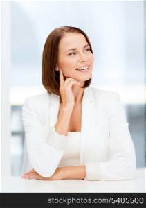 business concept - young woman dreaming in office