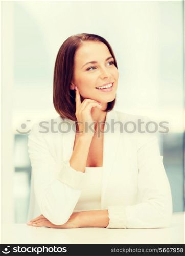 business concept - young woman dreaming in office