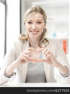business concept - young woman showing heart sign