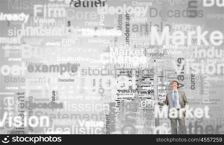 Business concepts. Young businessman writing business words with huge pencil