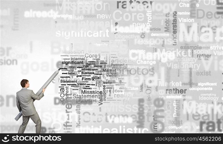 Business concepts. Young businessman writing business words with huge pencil