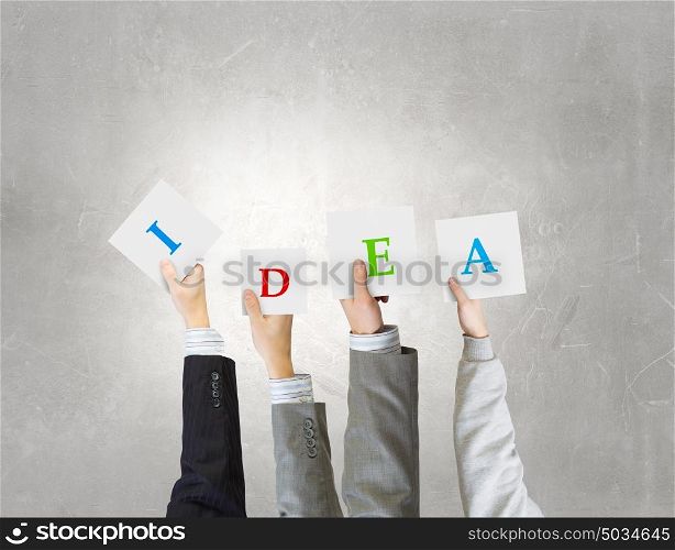 Business conceptual keywords. Group of business people holding in hands cards with letters