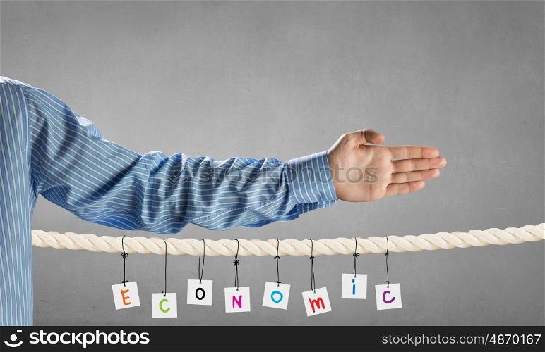 Business conceptual word. Close view of businessman hand and business concepts on rope