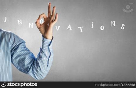 Business conceptual word. Close view of businessman hand showing ok gesture and business conceptual word