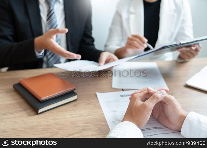 Business consulting candidate employee in suit looking skeptical reading a resume, hr speaking at job interview and recruitment concept