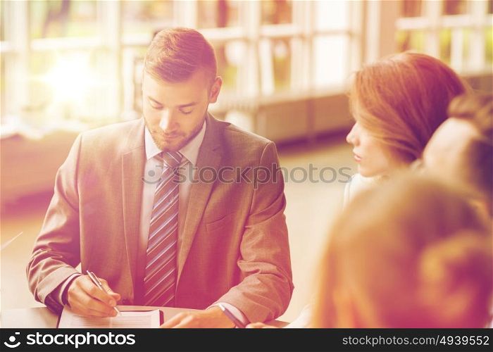 business, cooperation, people and partnership concept - business team with papers or contract meeting at office. business people meeting at office