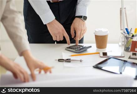 business, corporate and people concept - close up of businessman counting by calculator at office. close up of businessman with calculator at office