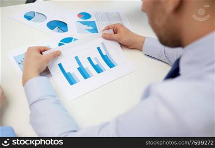 business, corporate and people concept - close up of businessman&rsquo;s hands with charts at office. close up of businessman&rsquo;s hands with charts