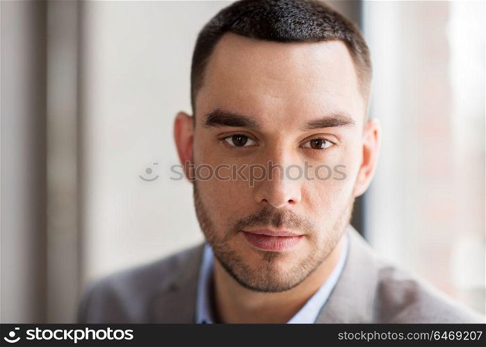 business, corporate and people concept - portrait of businessman in suit at office. portrait of businessman in suit at office