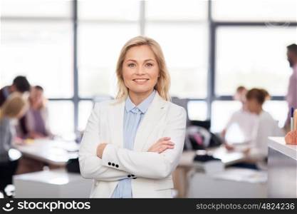 business, corporate and people concept - smiling businesswoman at office