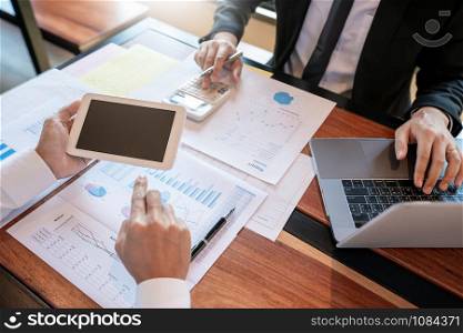 Business Corporate team brainstorming, Planning Strategy having a discussion Analysis investment researching with chart at office his desk documents and saving concept.