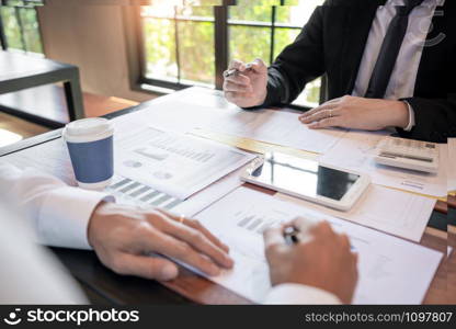 Business Corporate team brainstorming, Planning Strategy having a discussion Analysis investment researching with chart at office his desk documents and saving concept.