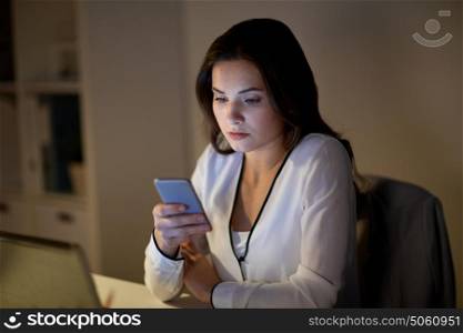 business, corporate, technology and people concept - businesswoman with smartphone at office. businesswoman with smartphone at office
