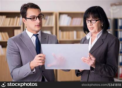 Business couple discussing business results on tablet