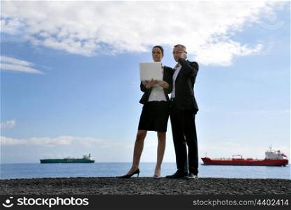 Business couple in front of tankers