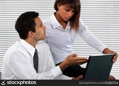 Business couple looking at a laptop