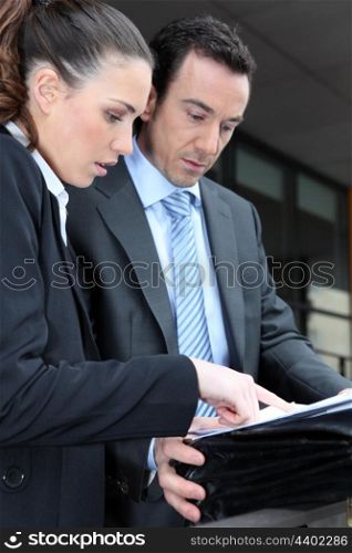 Business couple looking at paperwork or a map