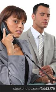 Business couple making important call