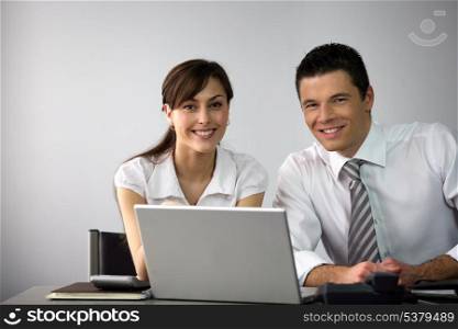 Business couple sat at desk