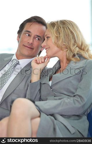 Business couple sharing a secret