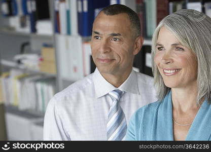 Business couple standing in office, portrait, elevated view