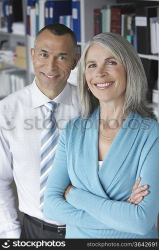 Business couple standing in office, portrait, elevated view