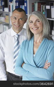 Business couple standing in office, portrait, elevated view