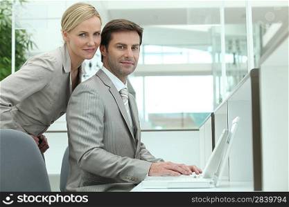 Business couple using a laptop computer