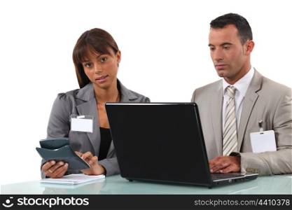 Business couple with a laptop and calculator