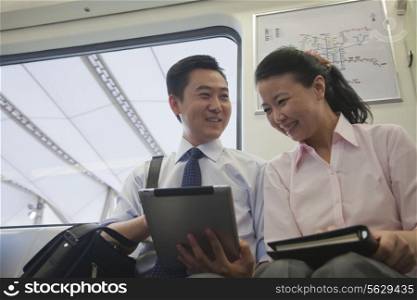 business couple working in the subway