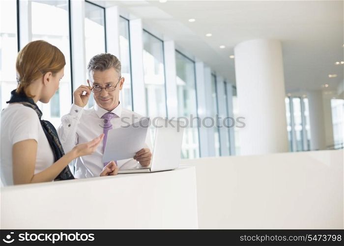 Business coworkers discussing work in office