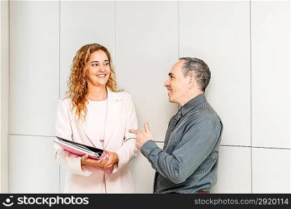 Business coworkers talking in hallway