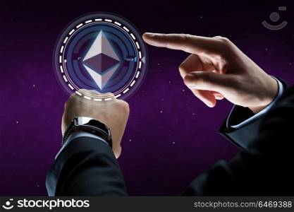 business, cryptocurrency and future technology concept - close up of businessman hands with smart watch hand ethereum hologram over ultra violet space background. male hands with smart watch and ethereum hologram